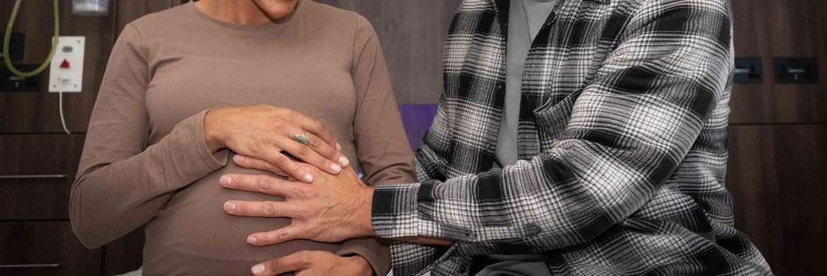 man holding a pregnant ladies stomach