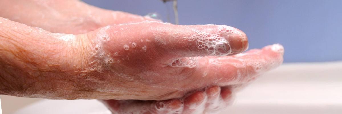 Person washing their hands in a sink