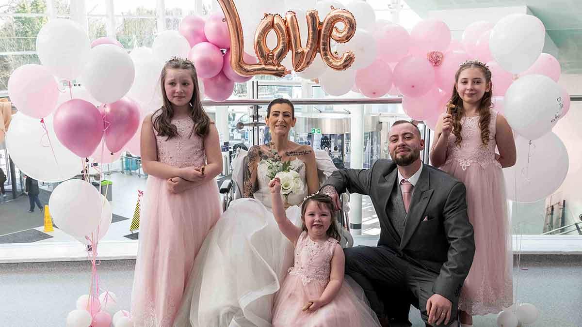 The bride and groom, pictured here with their three bridesmaids