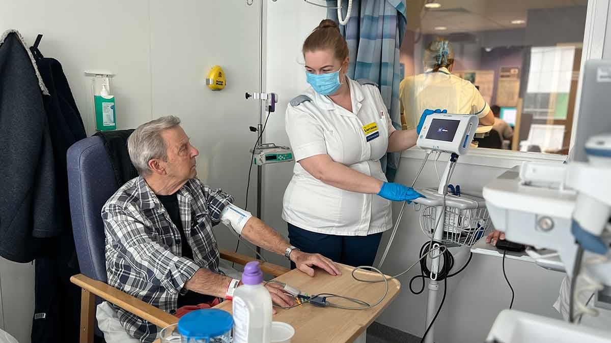 Lorraine Evans, a trainee nursing associate, with neurology patient Don Perks, on Ward 411.